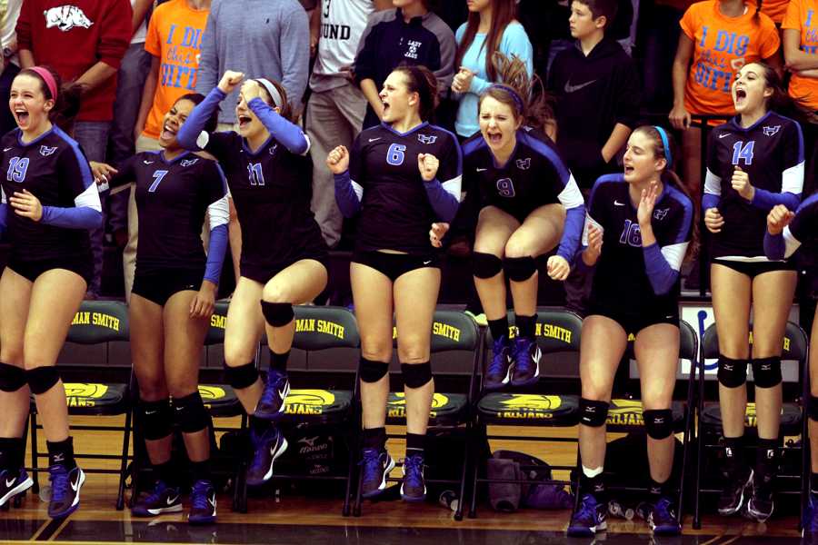 The team celebrates after making a point off a spike. 