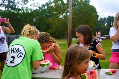 The 10 and under children's group chew through five pieces of watermelon.