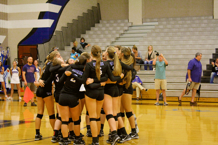 The team huddles and gives a pep talk before the first match of the game. 