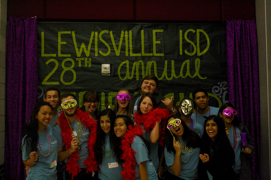 All the student council officers pose for a picture in front of Lewisvilles Photo Booth wall.
