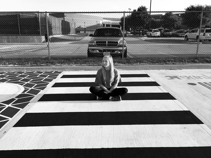 Senior+Avery+Crowe+sits+in+her+parking+spot.+Due+to+her+relapse+in+late+August+of+2016%2C+Avery+lost+memory+of+painting+it.