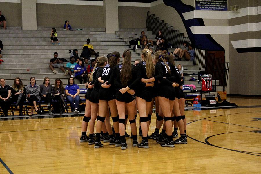 The team huddles together  before the game begins. 