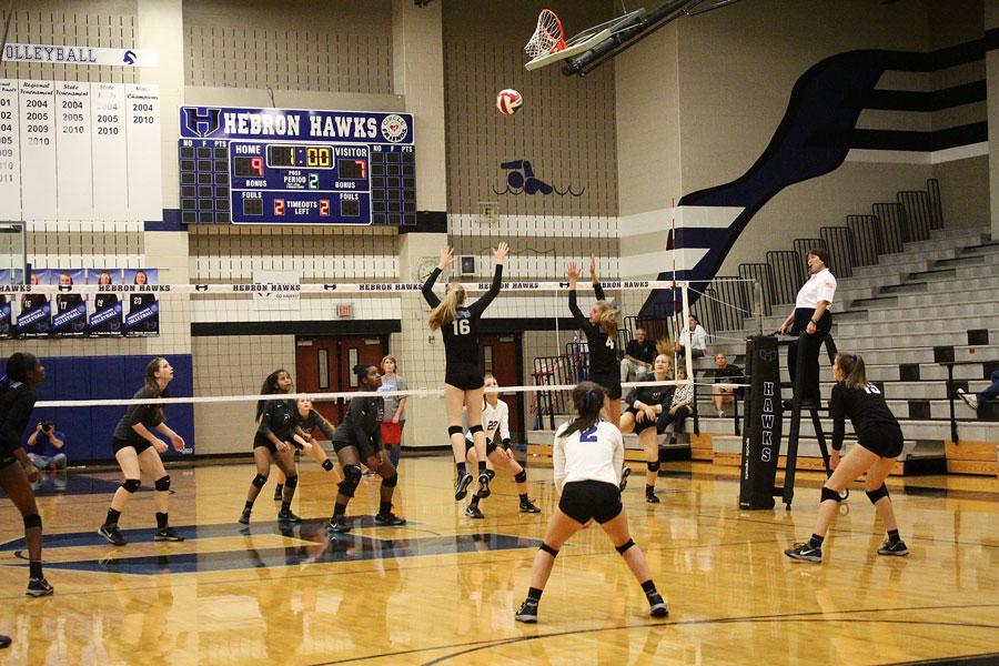 Sophomore Emma Clothier and Senior Kylee McLaughlin block the incoming spike.