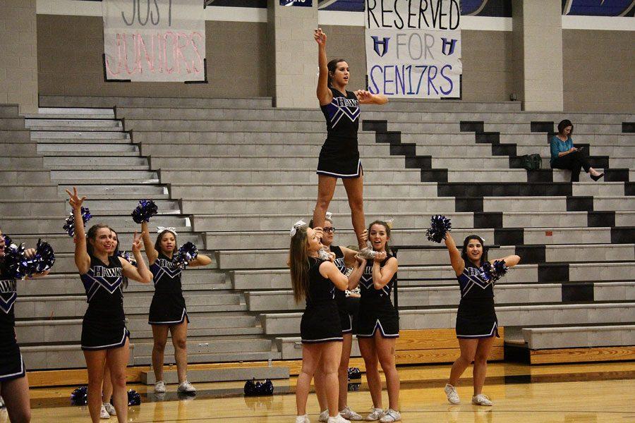 The schools cheerleaders encourage the Lady Hawks volleyball team throughout the game.