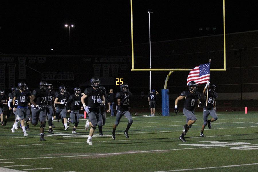 The football team returns to the field after half time. 