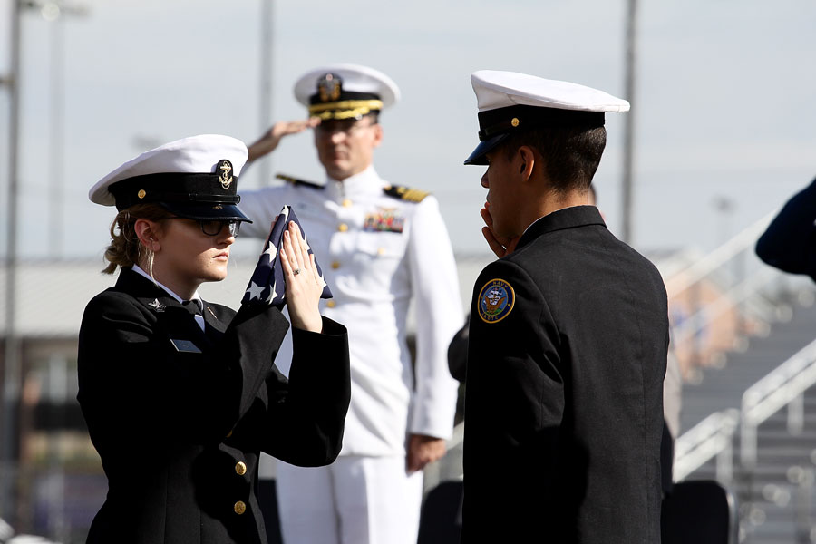 Junior Sophia Hunt accepts the flag as she is saluted. Konnor Halteman recited My Name Is Old Glory as the routine was done.