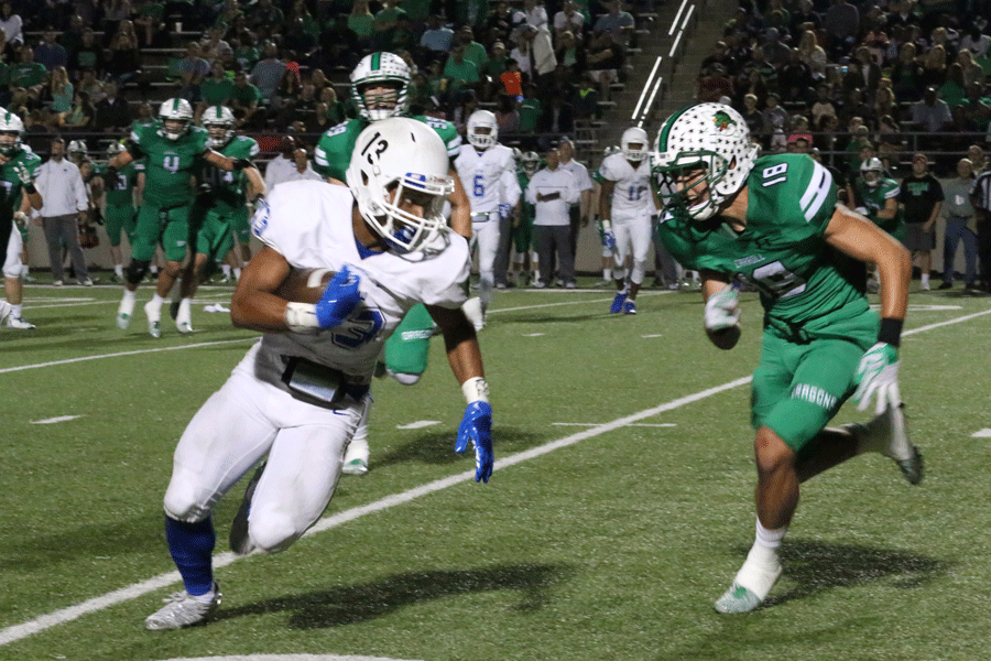 Junior Jaren Mitchell runs the ball down the field.