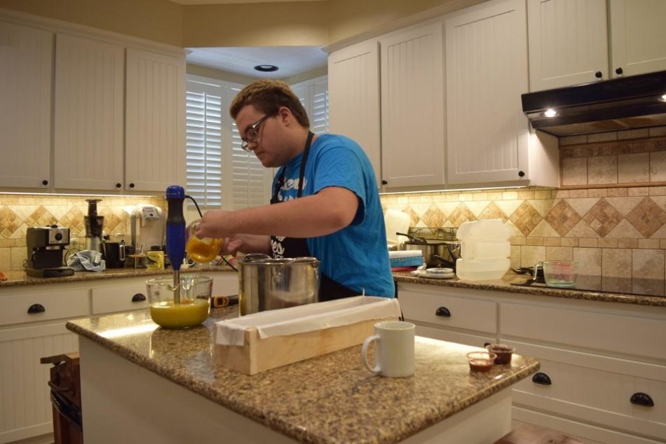 Bailey blends ingredients together before pouring the mixture into molds.