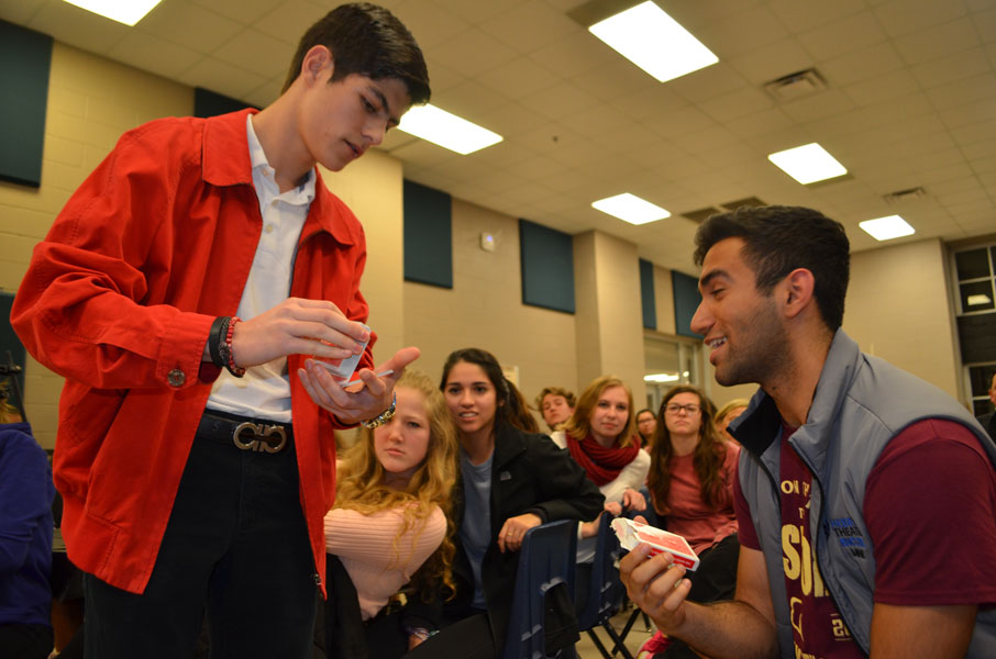 The audience participates in a card trick.