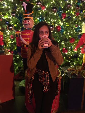 Me drinking hot chocolate Downtown Disneyland in front of some of the many Christmas decorations there.