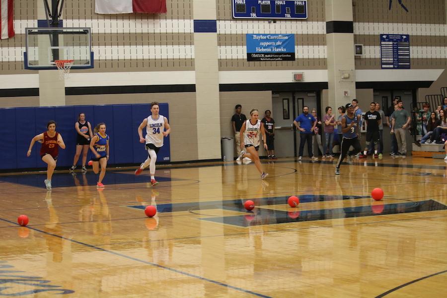 Seniors run forward to retrieve dodgeballs for the upcoming game.