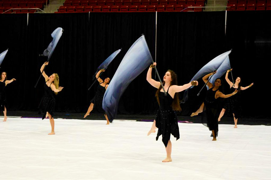 The Colorguard goes through their routine at the competition. They had to redo their routine seven times to accommodate for injuries and problems during practice.