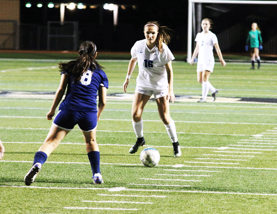 Junior Brooke Weatherford faces off against the other team.