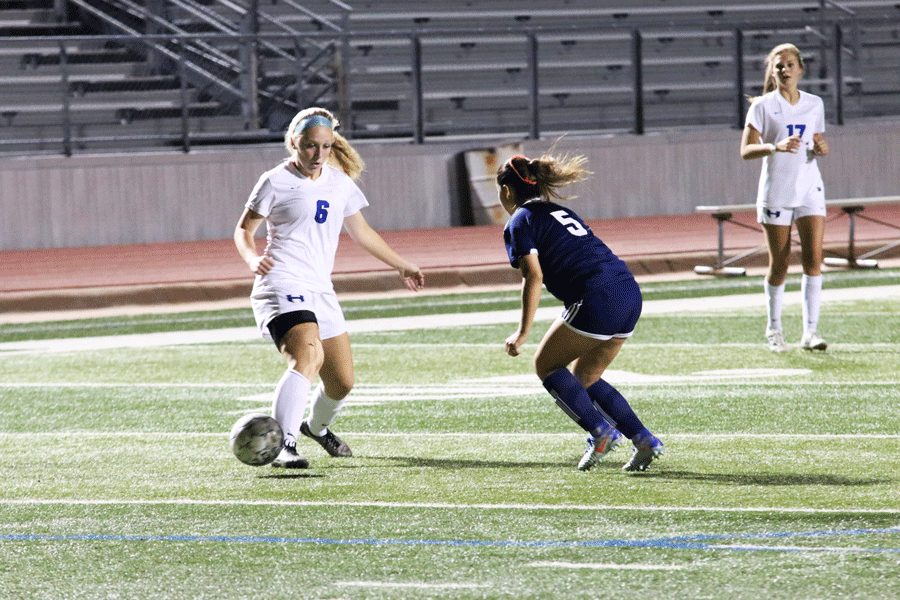Junior Caroline Workley receives the ball and protects it from her opponent.