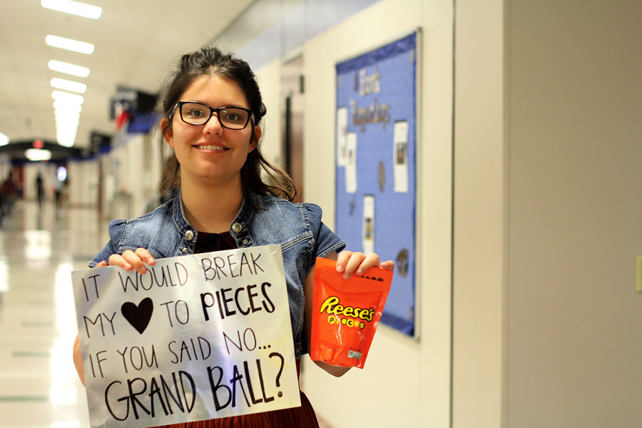 Junior Hannah Buell poses with a poster given to her by her date to the Grand Ball. 