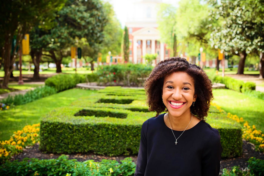 Connor poses for her senior pictures in front of the Patt Neff building at Baylor.