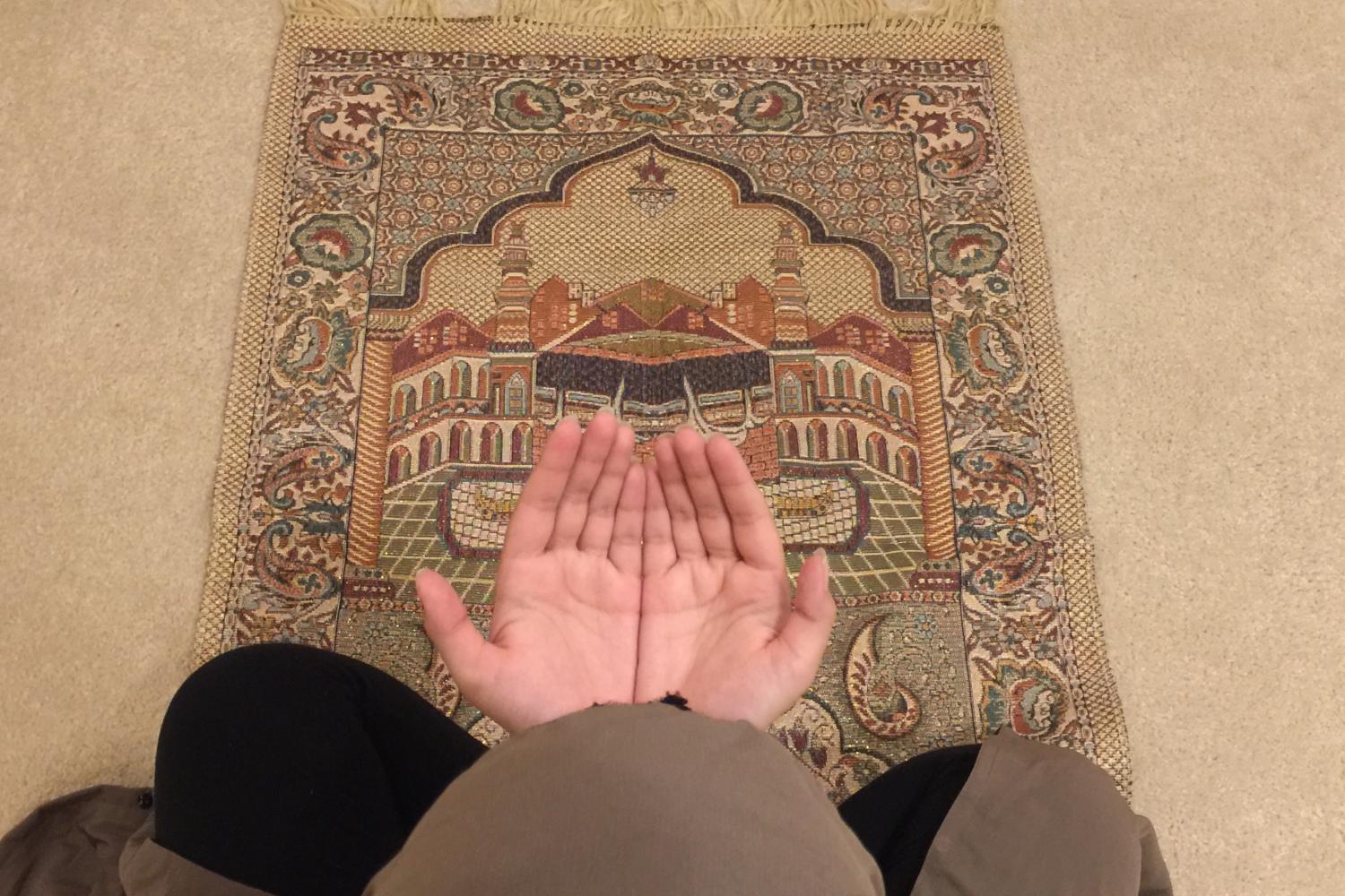 News Editor Yusra Waris, holds up her hands for prayer. 