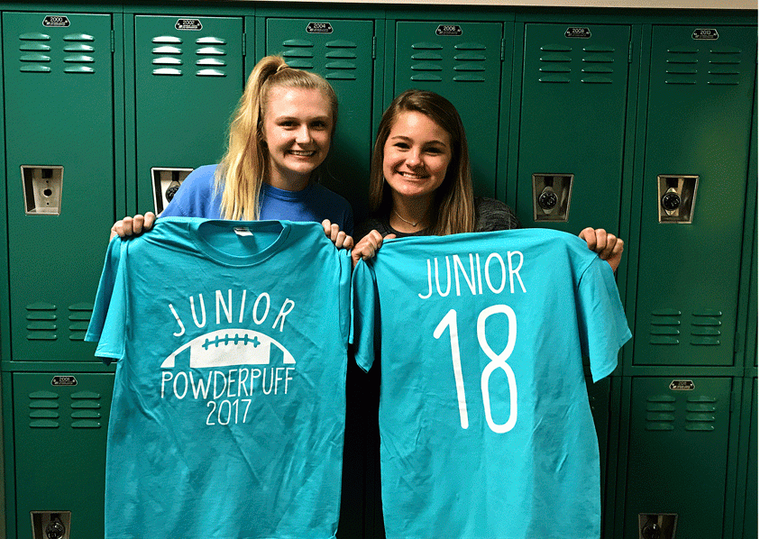 Juniors Kyra Kalman and Brenna Mckinnis hold up this years Powder Puff t-shirts.