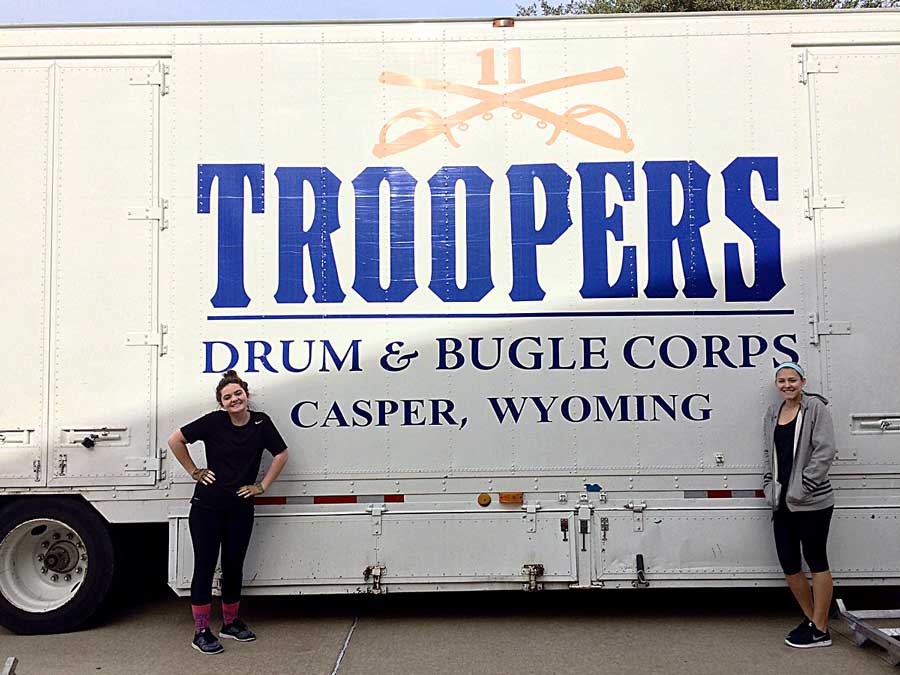 Seniors Juliann Page and Sophie Malis pose by the Troopers bus. They posted this photo to social media to announce that they were contracted with the drum corps. 