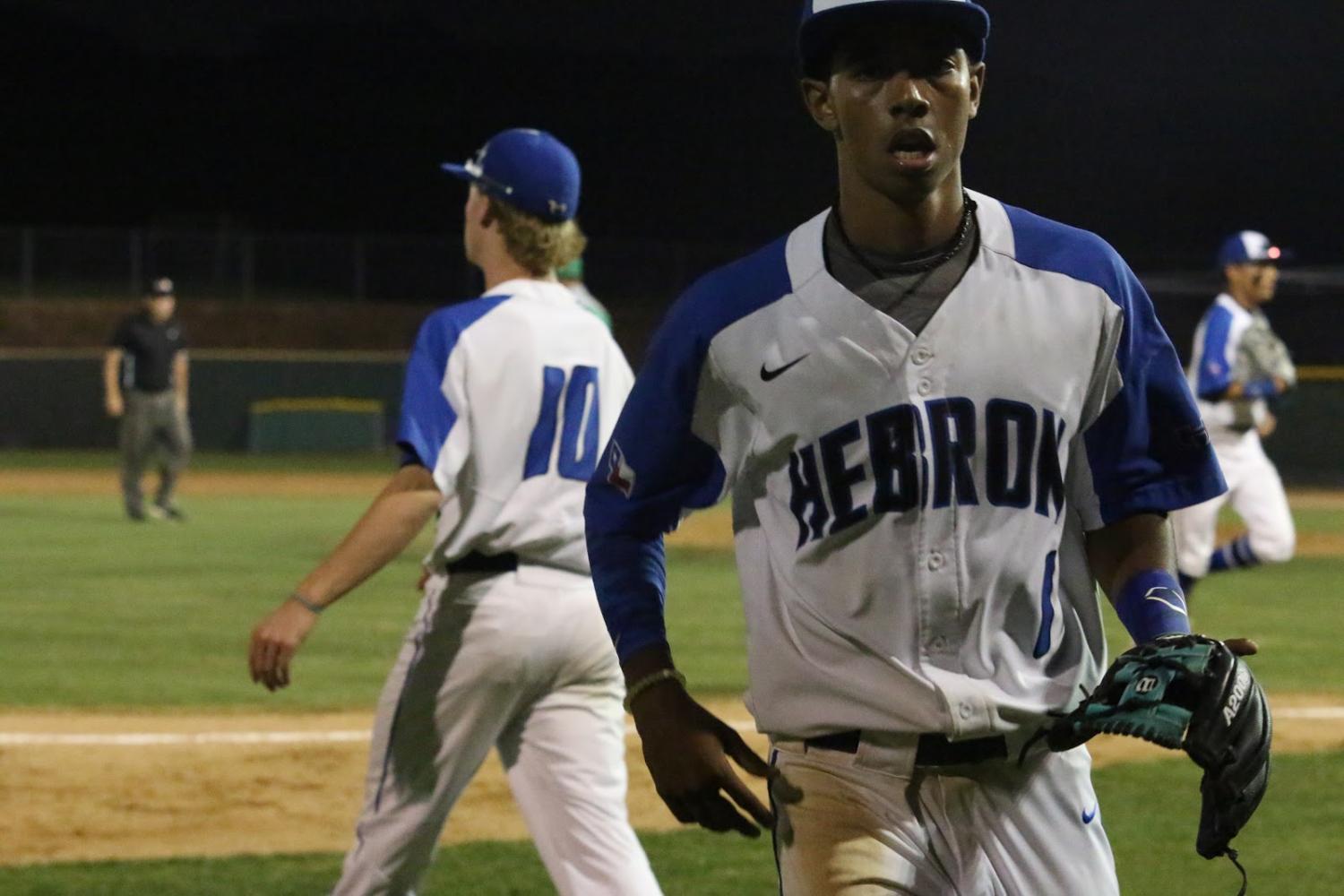 Senior Diego Johnson runs to the dugout as the half-inning comes to an end. Johnson had a fly out during the sixth inning.