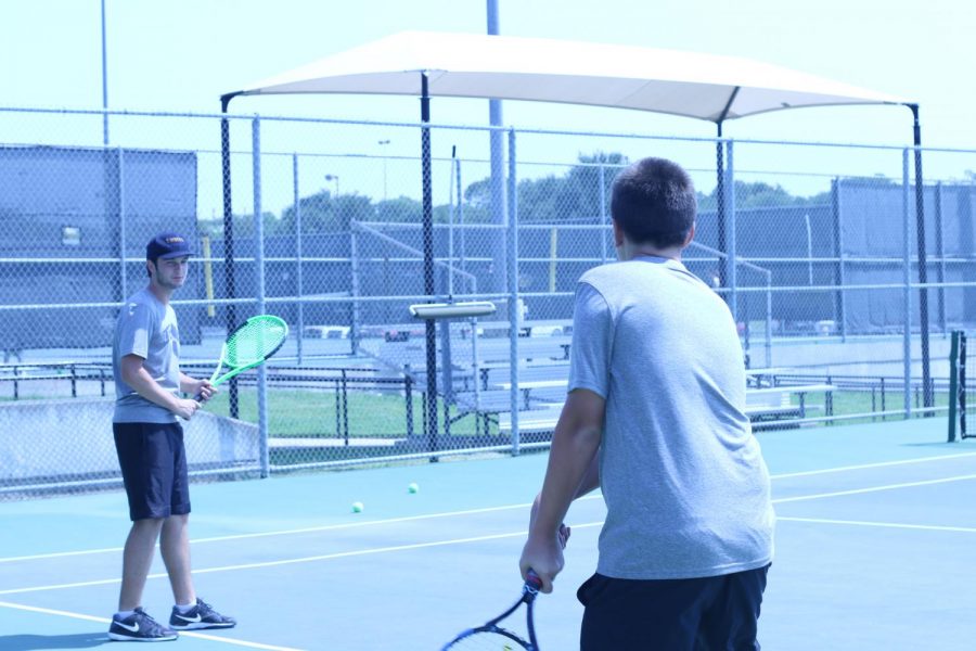 Tennis practices before heading to a tournament. Varsity defeated Lewisville at an away game on Oct. 3. 