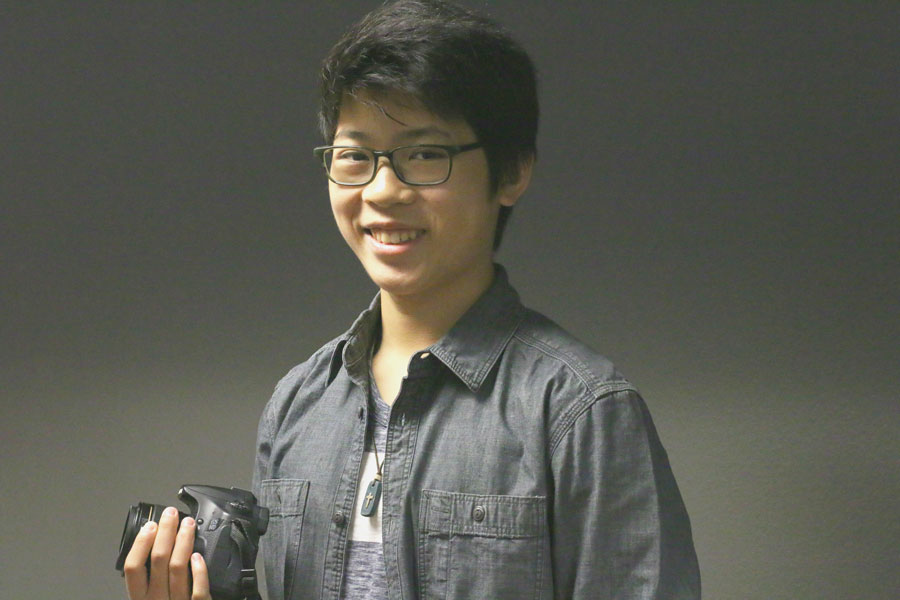 Junior Jacob Vu poses with a camera. He got his first camera, a Sony Handy-cam, when he was 9 years old. Currently, he usually uses a Canon camera for filming or photography.