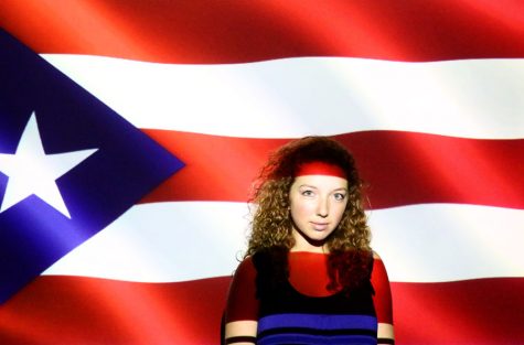 Senior Kierstin Hanifan stands in front of the Puerto Rican flag.
