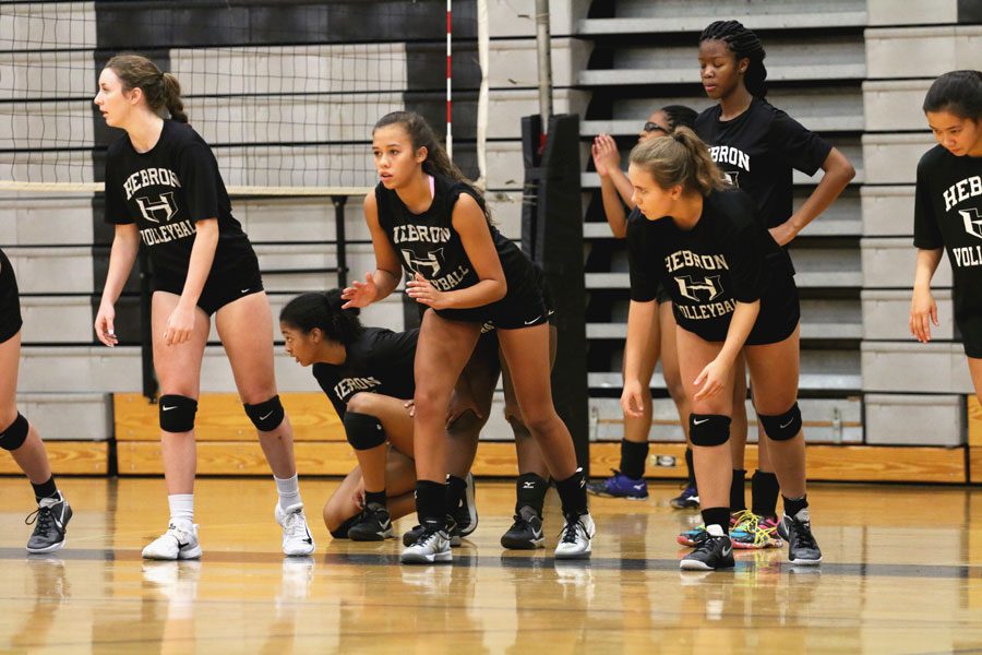 The volleyball team prepares to run sprints as they warm up for a tough practice. They play Marcus on Friday. 