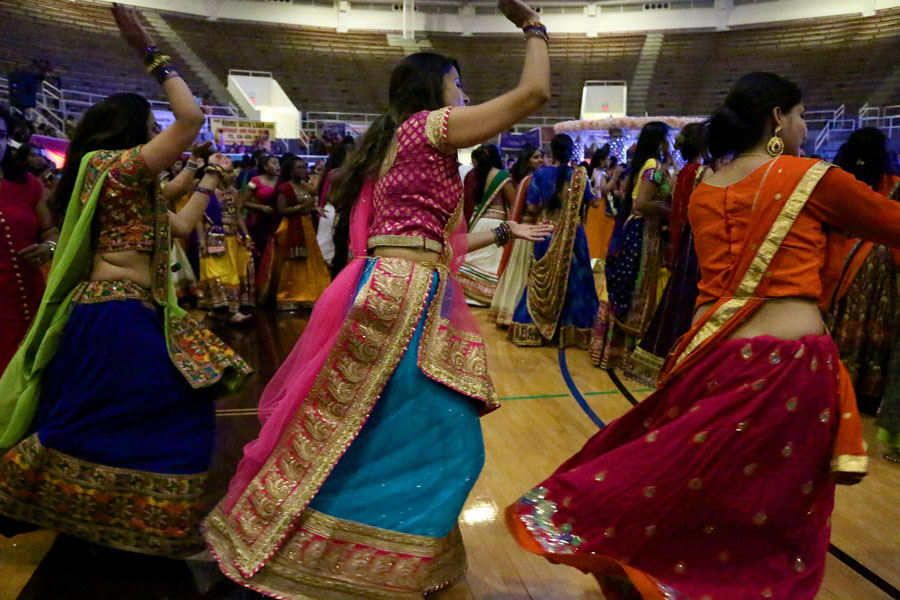 Three women start their own circle of dance as Garba starts. 