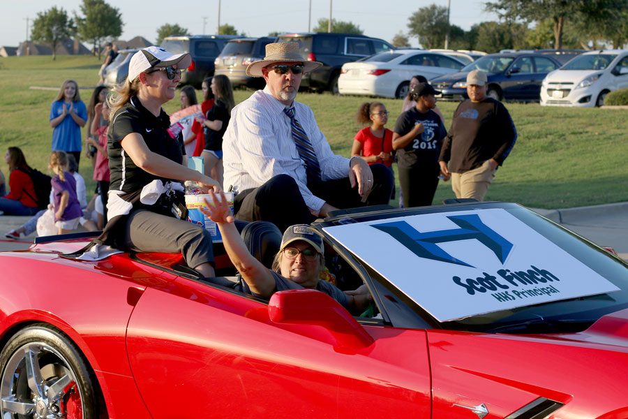 Principal Scot Finch and ninth grade center principal Amanda Werneke follow behind ROTC. The principals were the first of many administrators who drove through.