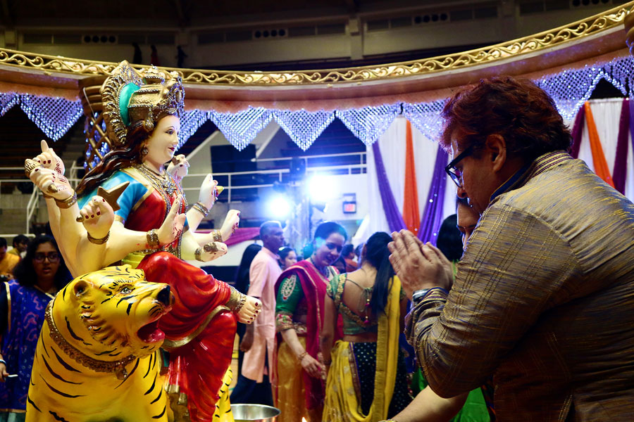 After aarti, a part of worship, is performed for Goddess Durga, people seek her blessings before Dandiya Raas begins.