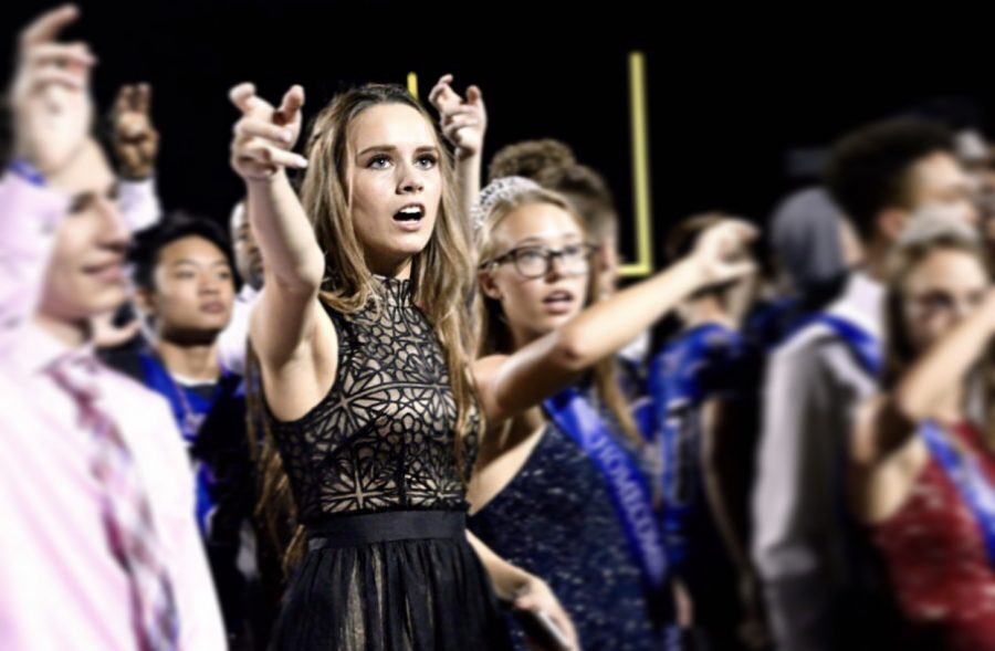 Senior Skylar Boyd sings the alma mater with the rest of the students during the Homecoming game. Boyd was one of the Homecoming Queen nominees.