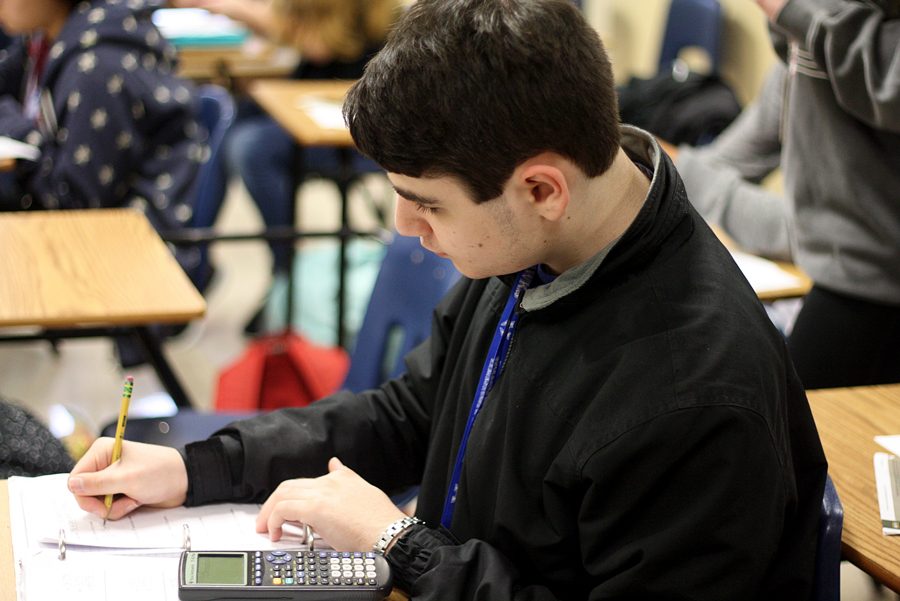 Junior Elliott Saltar works on an assignment in his chemistry class. He has been in all general education classes since he was a sophomore. 