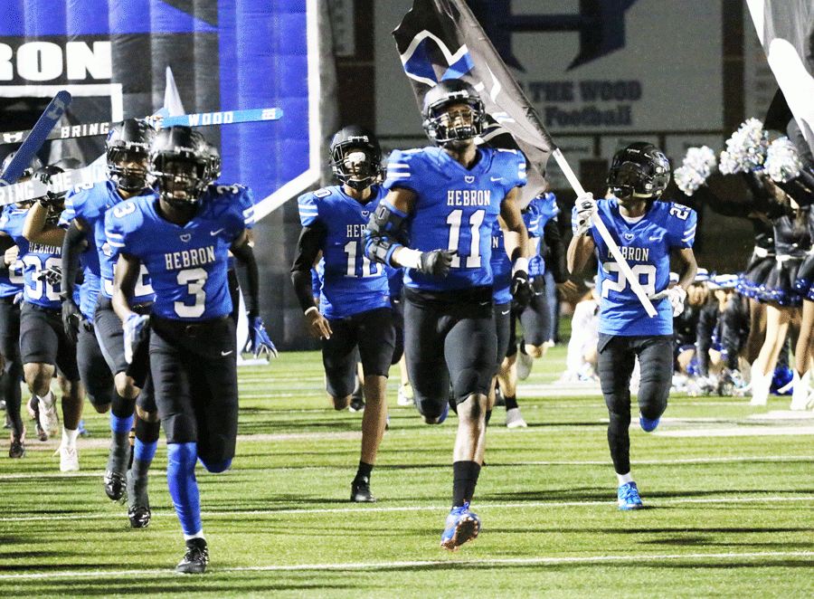The+football+players+charge+onto+the+field+for+the+game+against+Southlake+Carroll.+