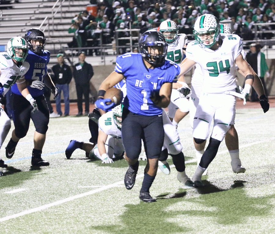 Senior running back Jatyn Taylor rushes for 5 yards to make a first down for Hebron.