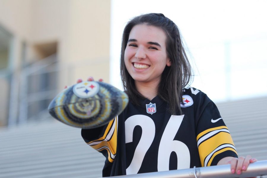 Junior+Isabel+Diaz+poses+with+a+football.