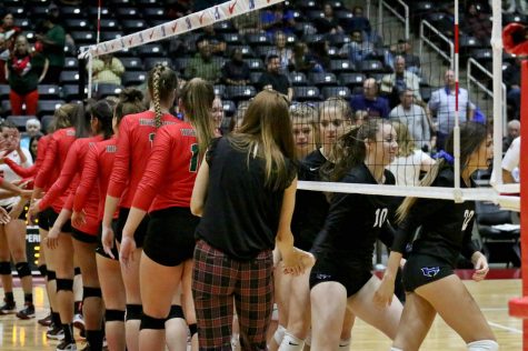 The Lady Hawks and Woodlands shake hands after the semifinals, in which the Lady Hawks won with a score of 3-0. The semifinals was held at the  Curtis Culwell Center in Garland on Nov. 17.
