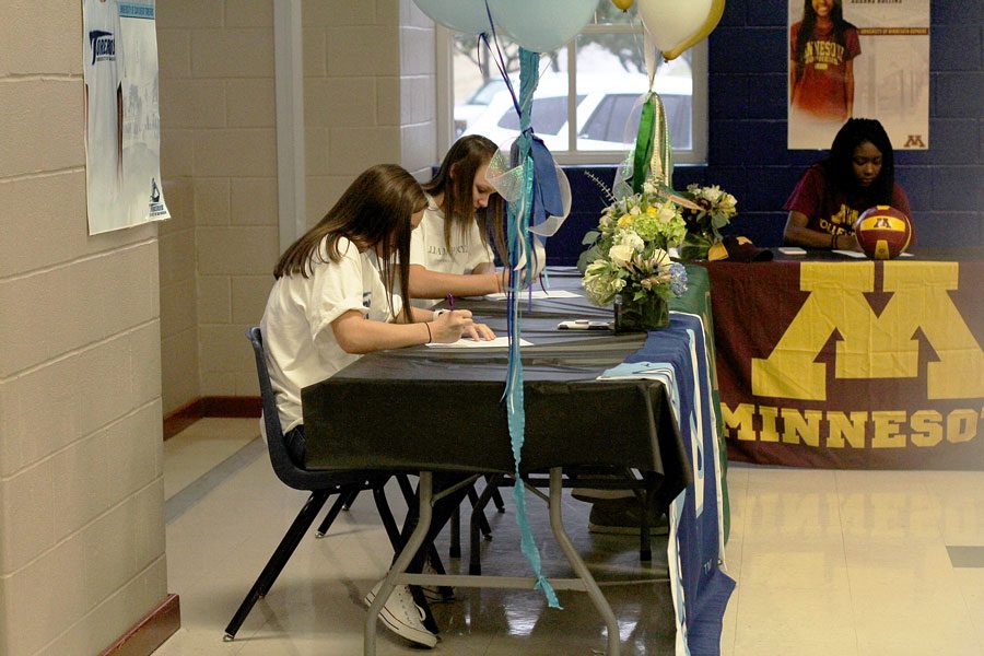 Seniors, Annie Benbow, Lauren Merrill, and Adanna Rollins signing their contracts to play for the colleges that they selected.  All three girls played on Varsity during the volleyball season. 