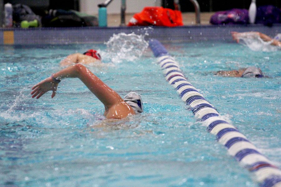 The swim and dive team practices at the Eastside Aquatic Center the morning of a Hebron Hawks invitational.