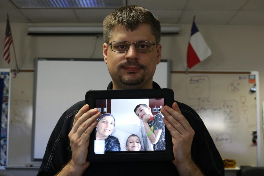 Mr. Stites poses with a picture of his wife and two sons. They were visiting her in the hospital. 