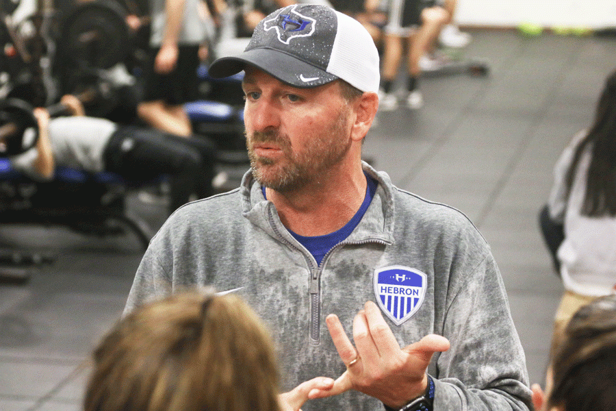 Head girls’ soccer coach Bobby Vaughn stands in front of the players instructing them while in the weight room. Vaughn became the head coach of the team a little over one year ago. 