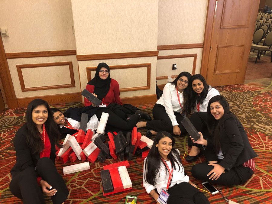 FCCLA members sit on the floor with their awards. They won 13 gold medals. 
