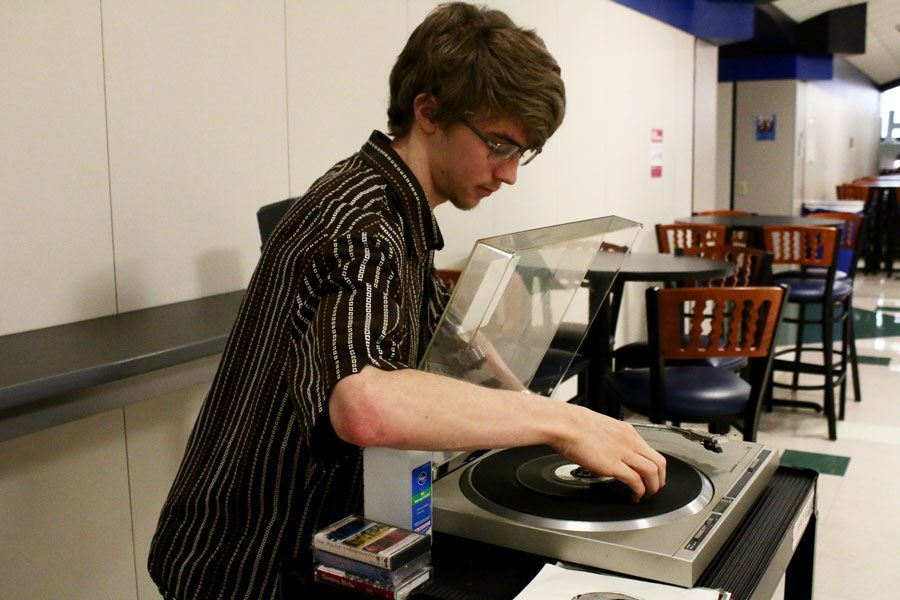 Senior Patrick Curran makes adjustments to a 1970s stero system.