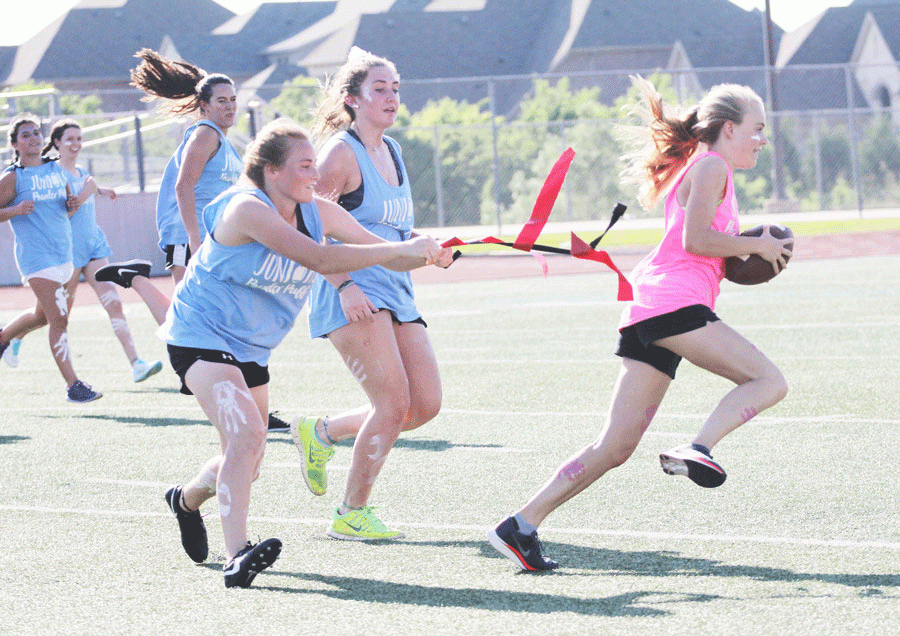 Junior Macey Neuse and junior Sarah Regan take the flags off of a senior player, putting the juniors back on offense. 