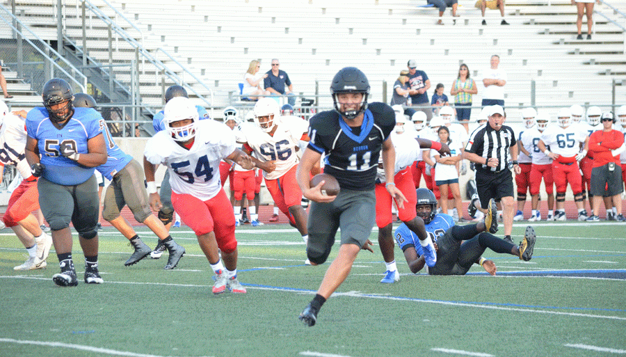 A Hebron quarterback breaks free from the Allen defense and runs the ball down the field.