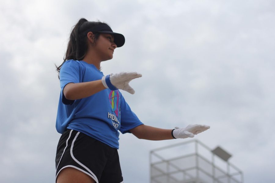 Sophomore Michelle Arriaga conducts during an afternoon band rehearsal. She arrives early and stays late for every practice to help out and to be there people. “I definitely have to dedicate a lot more time to the band program now,” Arriaga said. 