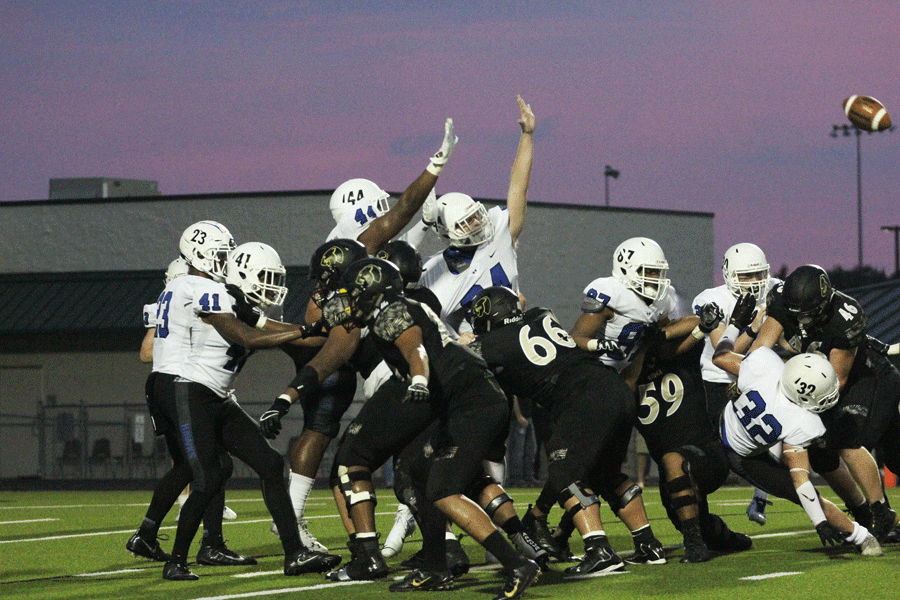 The Hebron defensive line attempts to block a Fossil ridge field goal. 