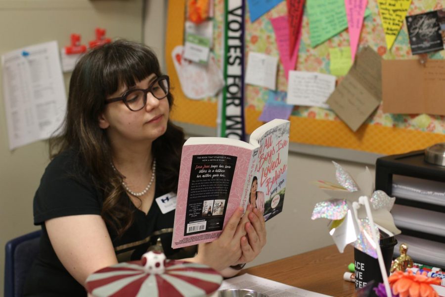 English teacher Nicole Perkins reads at her desk before school hours. Despite living a self-appointed ‘crazy, but in a sad way’ life, Perkins consistently has a smile on her face and a witty remark on her tongue during her class periods. “At the end of the day, we’re all learning, and sometimes that’s all you can ask for,” Perkins said. 