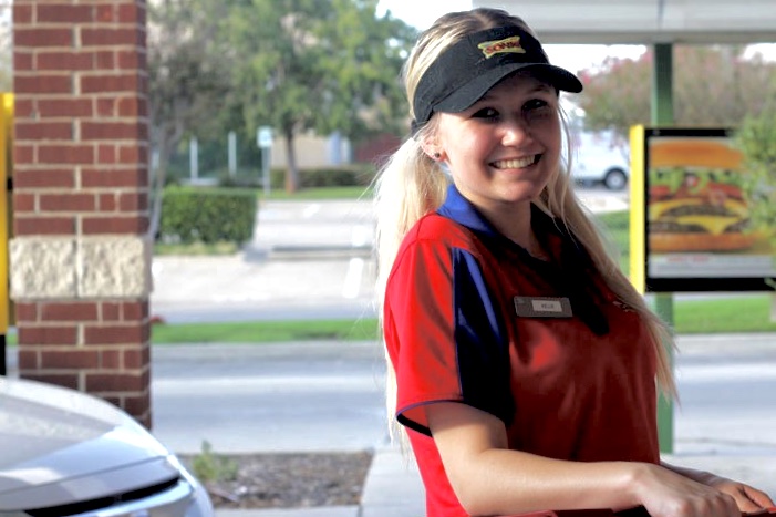 Junior Kellie Casburn poses at Sonic as she finishes delivering an order to a customer. Casburn said she wants to find a good job to support herself after she graduates.
