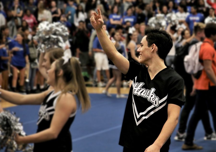 Sophomore Nathan Drew cheers at the pep rally held on October 5th. The cheerleading team attends many school events to bring spirit and excitement to football games and more. “I cheer at all the JV games: football, volleyball, basketball, all of those,” he said. “We do pep rallies too, and if the school has a fundraiser event, we’re there.”